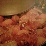 braised pineapple chicken in a pot with a lid